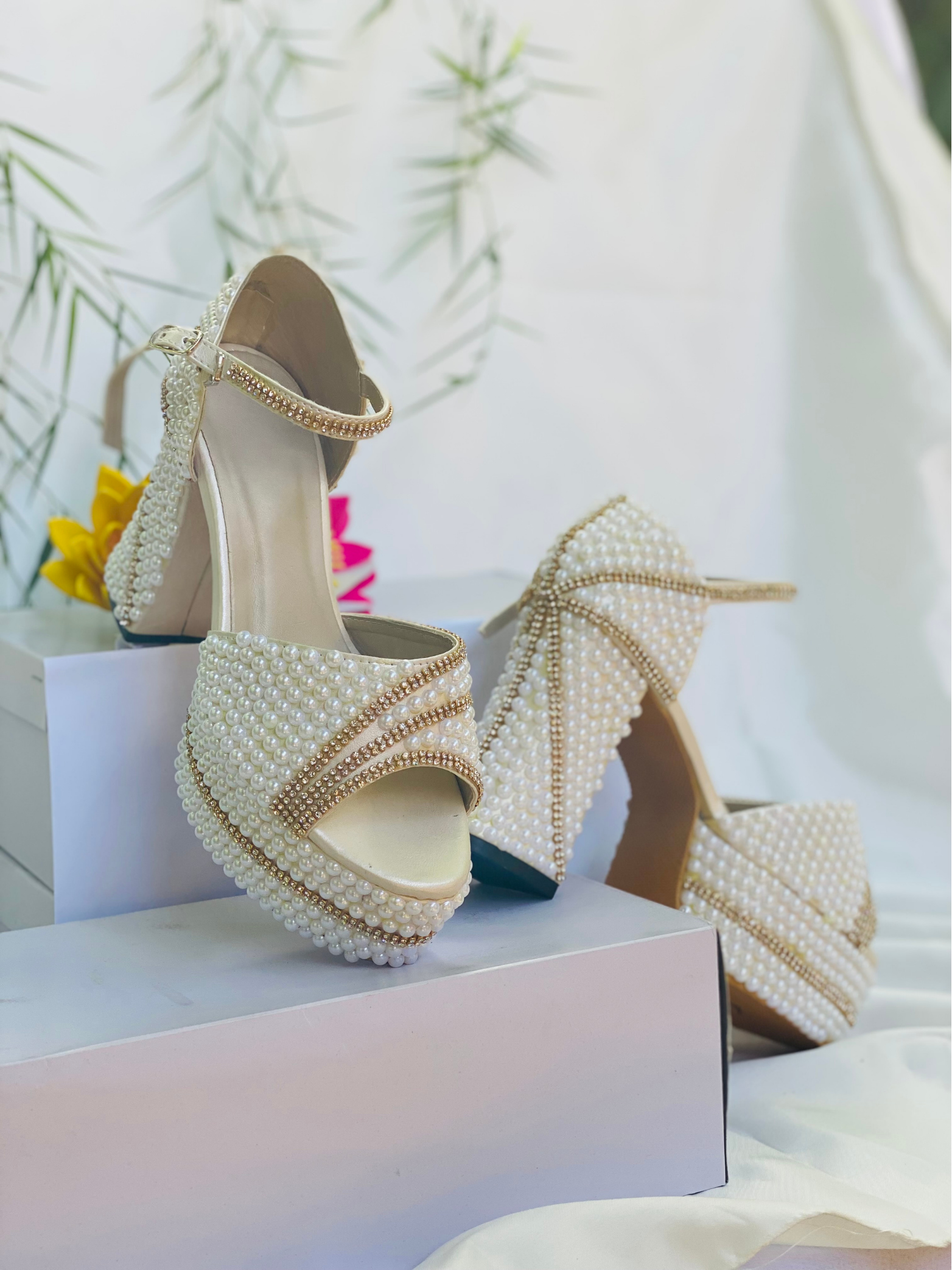 Ivory and blush bridal heel resting on a satin ribbon, studio still life