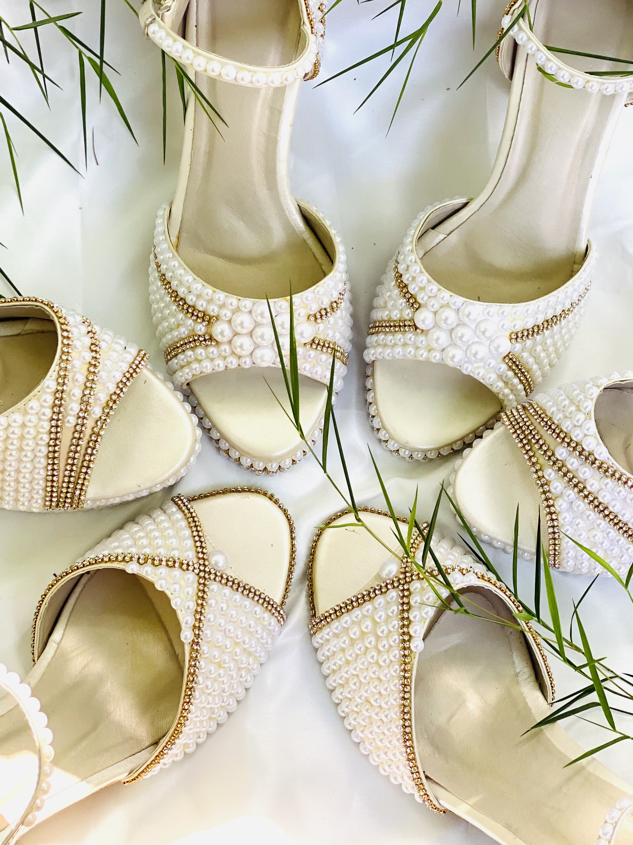 Bride adjusting the strap of an ivory Aurelia Heels bridal shoe